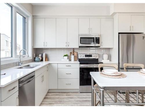 106-1453 Na'A Drive Sw, Calgary, AB - Indoor Photo Showing Kitchen With Double Sink With Upgraded Kitchen