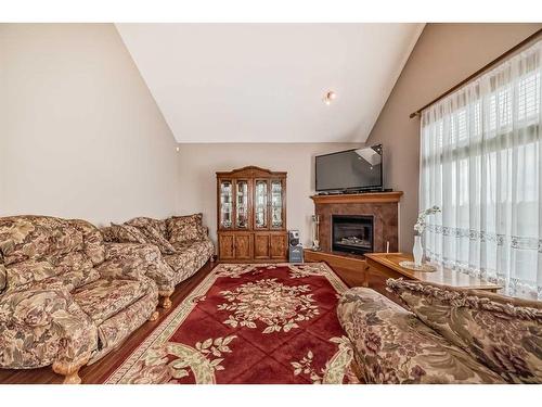 151 Bridlemeadows Common Sw, Calgary, AB - Indoor Photo Showing Living Room With Fireplace