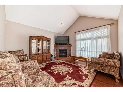 151 Bridlemeadows Common Sw, Calgary, AB - Indoor Photo Showing Living Room With Fireplace