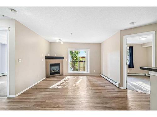 206-6315 Ranchview Drive Nw, Calgary, AB - Indoor Photo Showing Living Room With Fireplace