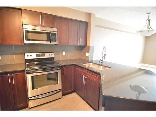 101-500 Rocky Vista Gardens Nw, Calgary, AB - Indoor Photo Showing Kitchen With Stainless Steel Kitchen