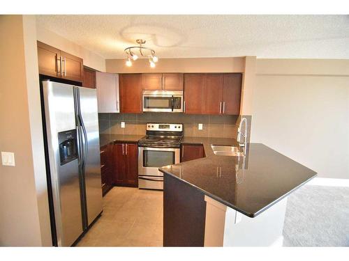 101-500 Rocky Vista Gardens Nw, Calgary, AB - Indoor Photo Showing Kitchen With Stainless Steel Kitchen