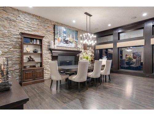 12 Westbluff Bay, Rural Rocky View County, AB - Indoor Photo Showing Dining Room With Fireplace