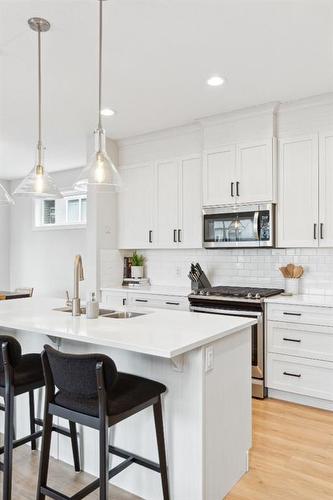 285 Sage Bluff Drive Nw, Calgary, AB - Indoor Photo Showing Kitchen With Double Sink With Upgraded Kitchen