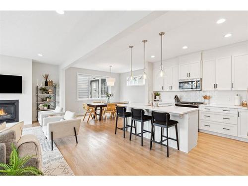 285 Sage Bluff Drive Nw, Calgary, AB - Indoor Photo Showing Kitchen With Fireplace With Upgraded Kitchen