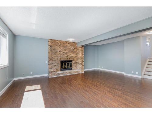 191 Scenic Way Nw, Calgary, AB - Indoor Photo Showing Living Room With Fireplace