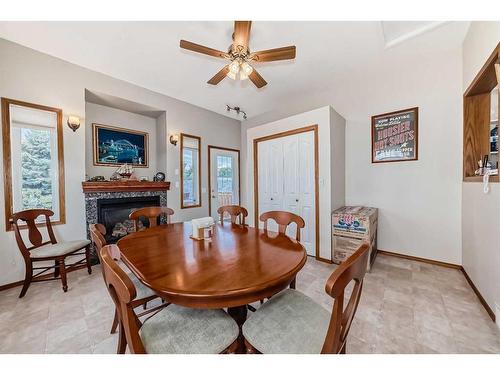 424 Cimarron Circle, Okotoks, AB - Indoor Photo Showing Dining Room With Fireplace