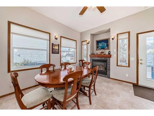 424 Cimarron Circle, Okotoks, AB - Indoor Photo Showing Dining Room With Fireplace