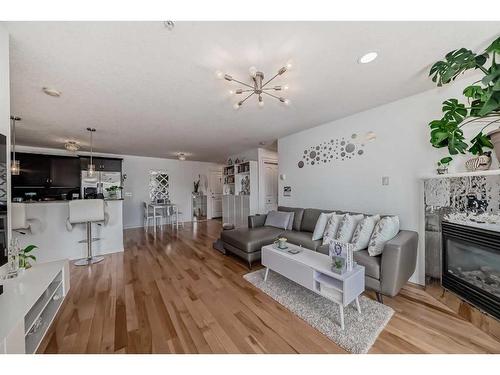 3211-10 Country Village Park Ne, Calgary, AB - Indoor Photo Showing Living Room With Fireplace