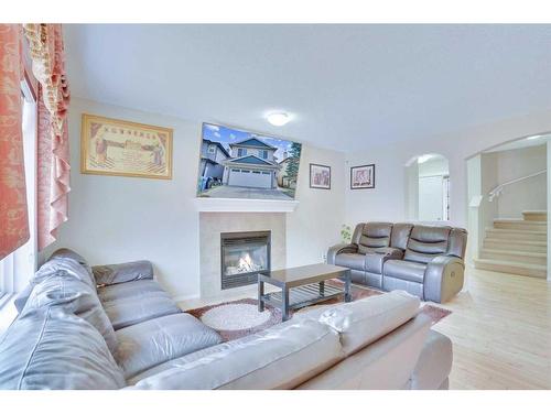 357 Saddlecrest Way Ne, Calgary, AB - Indoor Photo Showing Living Room With Fireplace