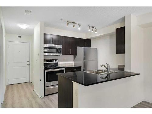 9112-403 Mackenzie Way, Airdrie, AB - Indoor Photo Showing Kitchen With Stainless Steel Kitchen With Double Sink