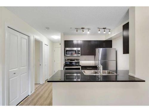 9112-403 Mackenzie Way, Airdrie, AB - Indoor Photo Showing Kitchen With Stainless Steel Kitchen With Double Sink