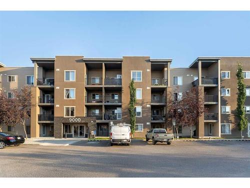 9112-403 Mackenzie Way, Airdrie, AB - Outdoor With Balcony With Facade