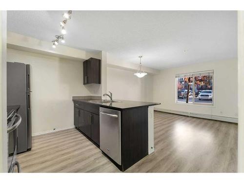 9112-403 Mackenzie Way, Airdrie, AB - Indoor Photo Showing Kitchen With Double Sink