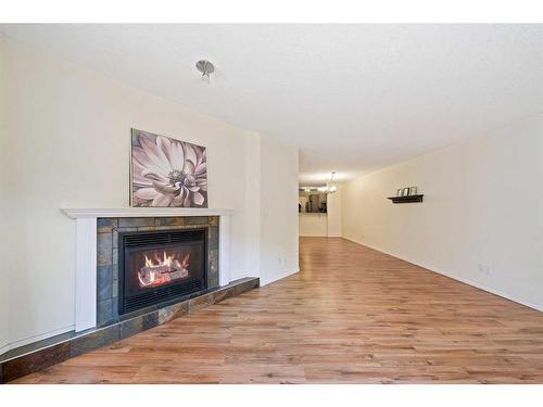 102-705 56 Avenue Sw, Calgary, AB - Indoor Photo Showing Living Room With Fireplace