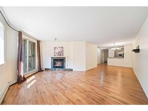 102-705 56 Avenue Sw, Calgary, AB - Indoor Photo Showing Living Room With Fireplace