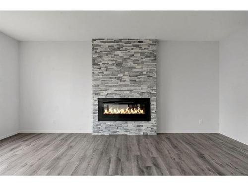 801 Windrow Green Sw, Airdrie, AB - Indoor Photo Showing Living Room With Fireplace