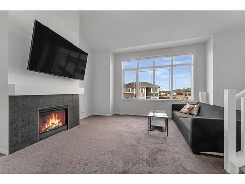 801 Windrow Green Sw, Airdrie, AB - Indoor Photo Showing Living Room With Fireplace