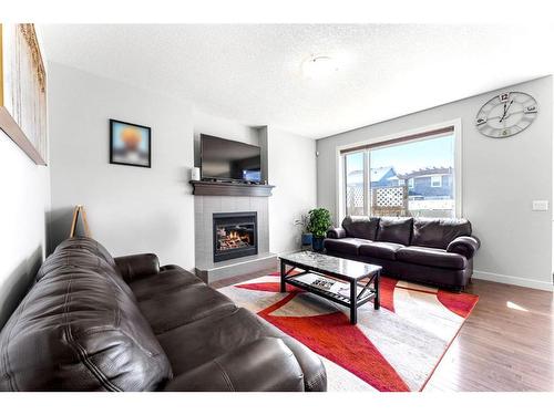 21 Redstone Road Ne, Calgary, AB - Indoor Photo Showing Living Room With Fireplace