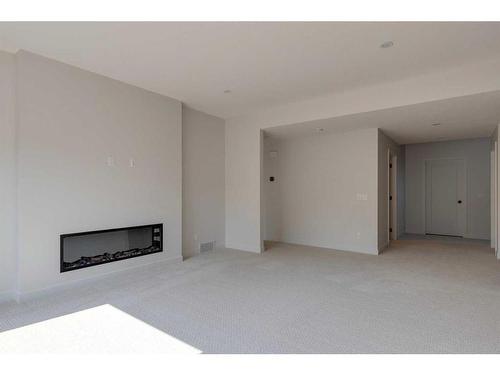 2 Rock Lake Heights Nw, Calgary, AB - Indoor Photo Showing Other Room With Fireplace