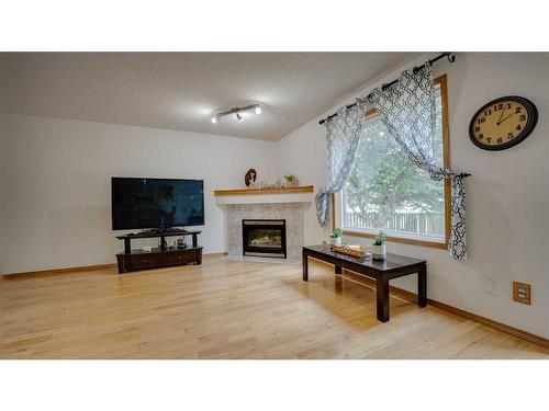 863 Tuscany Drive Nw, Calgary, AB - Indoor Photo Showing Living Room With Fireplace