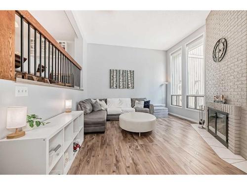 7-10401 19 Street Sw, Calgary, AB - Indoor Photo Showing Living Room With Fireplace