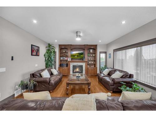 348 Kinniburgh Boulevard, Chestermere, AB - Indoor Photo Showing Living Room With Fireplace