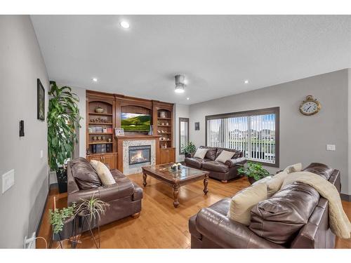 348 Kinniburgh Boulevard, Chestermere, AB - Indoor Photo Showing Living Room With Fireplace