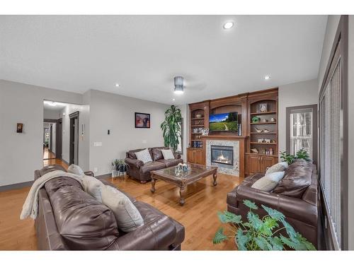 348 Kinniburgh Boulevard, Chestermere, AB - Indoor Photo Showing Living Room With Fireplace