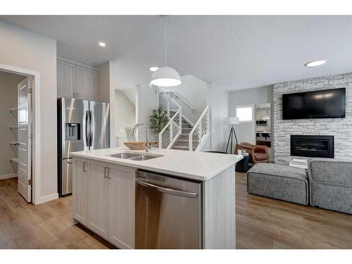 2773 Baywater Landing Sw, Airdrie, AB - Indoor Photo Showing Kitchen With Fireplace With Double Sink With Upgraded Kitchen