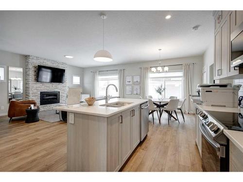 2773 Baywater Landing Sw, Airdrie, AB - Indoor Photo Showing Kitchen With Fireplace With Double Sink