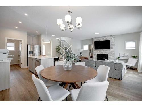 2773 Baywater Landing Sw, Airdrie, AB - Indoor Photo Showing Dining Room With Fireplace