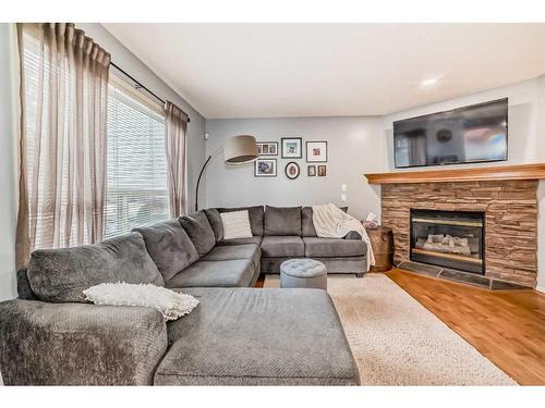 219 New Brighton Circle Se, Calgary, AB - Indoor Photo Showing Living Room With Fireplace