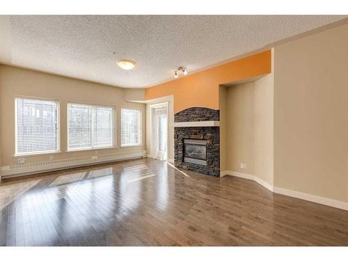 335-10 Discovery Ridge Close Sw, Calgary, AB - Indoor Photo Showing Living Room With Fireplace