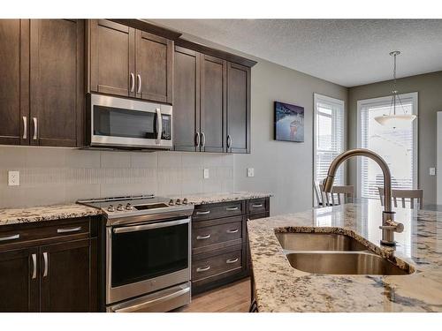 650 West Highland Crescent, Carstairs, AB - Indoor Photo Showing Kitchen With Double Sink With Upgraded Kitchen