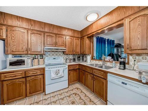 6023 Thornaby Way Nw, Calgary, AB - Indoor Photo Showing Kitchen With Double Sink