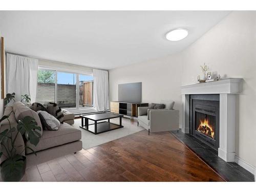 109-335 Garry Crescent Ne, Calgary, AB - Indoor Photo Showing Living Room With Fireplace