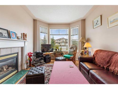 28 Country Hills Gardens Nw, Calgary, AB - Indoor Photo Showing Living Room With Fireplace