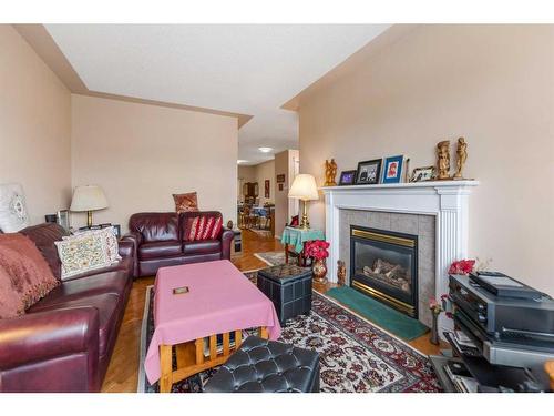 28 Country Hills Gardens Nw, Calgary, AB - Indoor Photo Showing Living Room With Fireplace