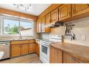 208 Tache Avenue Nw, Calgary, AB  - Indoor Photo Showing Kitchen With Double Sink 