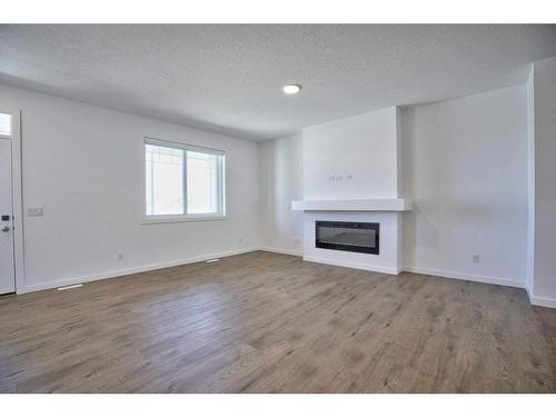 70 Legacy Reach Bay Se, Calgary, AB - Indoor Photo Showing Other Room With Fireplace