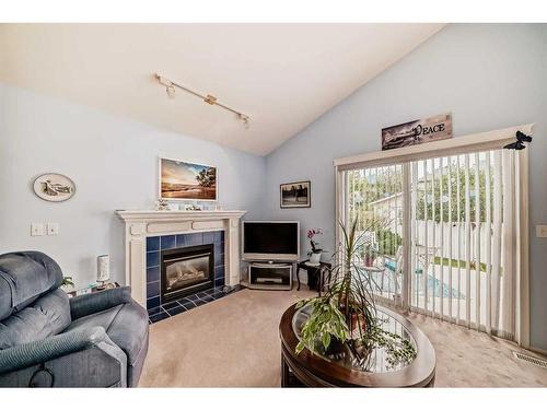 1070 Coventry Drive Ne, Calgary, AB - Indoor Photo Showing Living Room With Fireplace