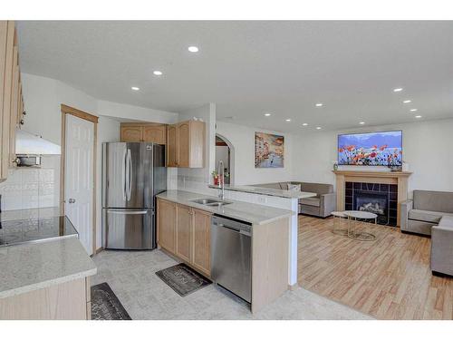 28 Tarawood Grove Ne, Calgary, AB - Indoor Photo Showing Kitchen With Fireplace With Double Sink