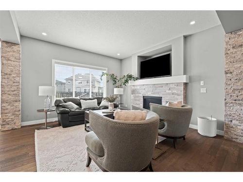 88 Rainbow Falls Blvd, Chestermere, AB - Indoor Photo Showing Living Room With Fireplace