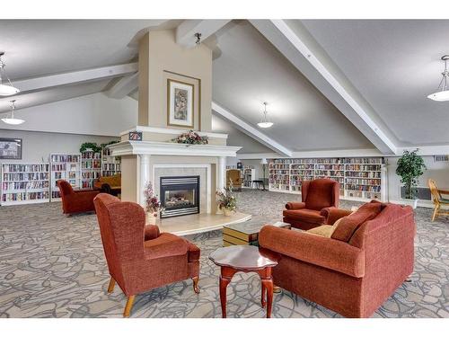 221-223 Tuscany Springs Boulevard Nw, Calgary, AB - Indoor Photo Showing Living Room With Fireplace