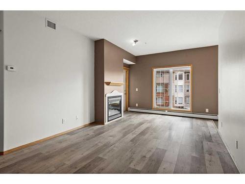 221-223 Tuscany Springs Boulevard Nw, Calgary, AB - Indoor Photo Showing Living Room With Fireplace