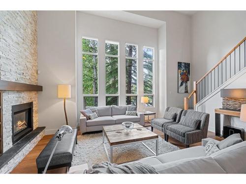 4-136 Silvertip Ridge, Canmore, AB - Indoor Photo Showing Living Room With Fireplace