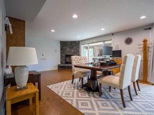 77 Royal Highland Road Nw, Calgary, AB - Indoor Photo Showing Dining Room With Fireplace