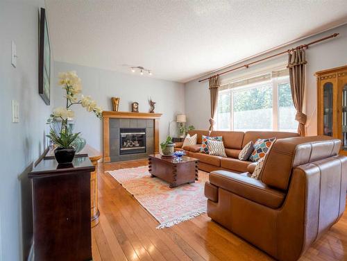 77 Royal Highland Road Nw, Calgary, AB - Indoor Photo Showing Living Room With Fireplace