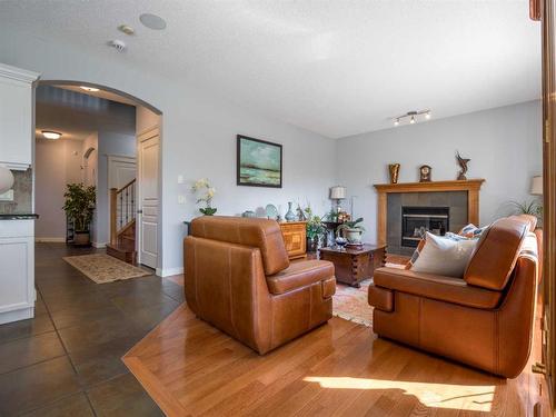 77 Royal Highland Road Nw, Calgary, AB - Indoor Photo Showing Living Room With Fireplace